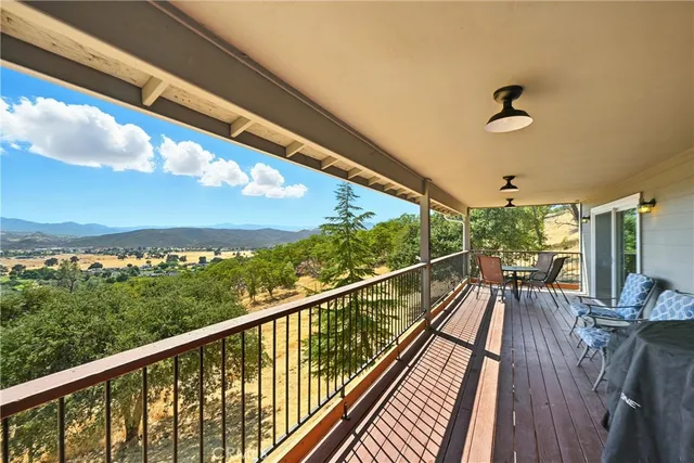 a view of a balcony with a table and chairs