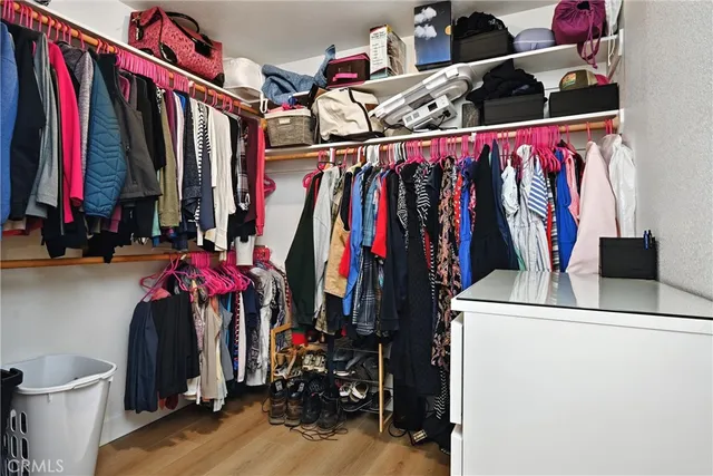 a view of a room with wooden floor and fan