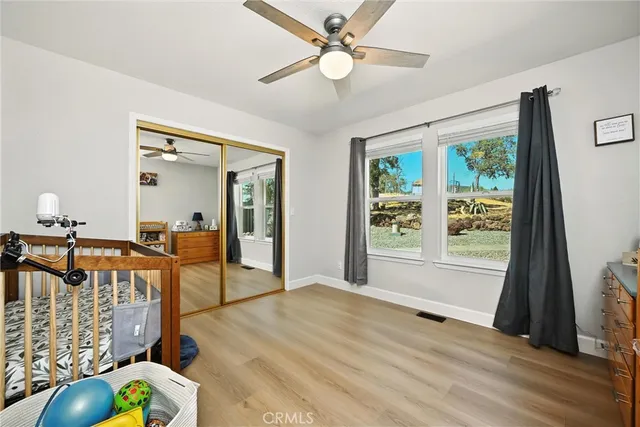 a bedroom with a bed and wooden floor