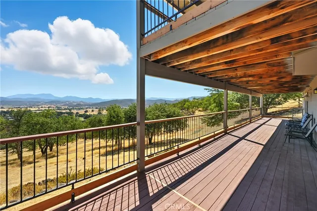 a view of a house with a big yard and large tree