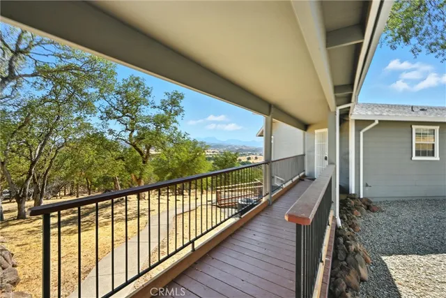 a view of a porch with a floor to ceiling window next to a yard
