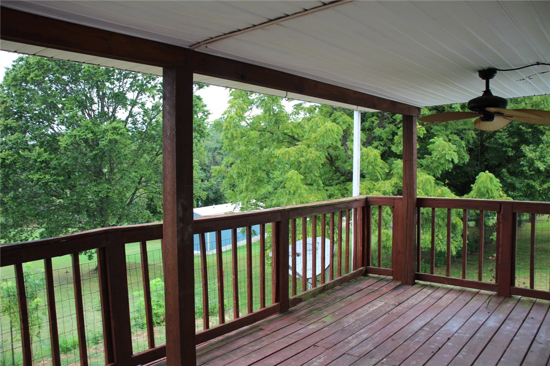 402 Canaan Road Marshall, AR 72650 - Photo 29 of 37 Covered outdoor deck with wood-finish flooring and railing