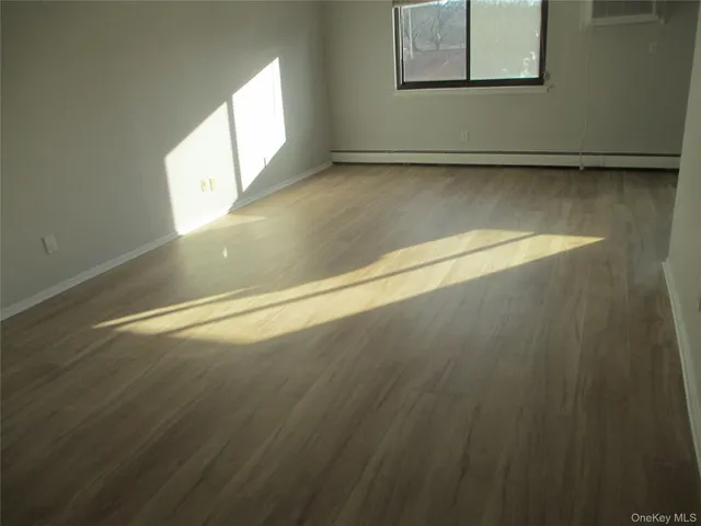a view of a room with wooden floor and windows