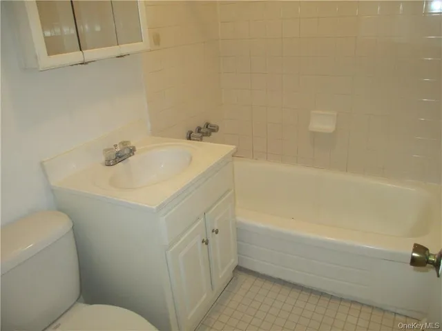 a bathroom with a sink a toilet and bathtub