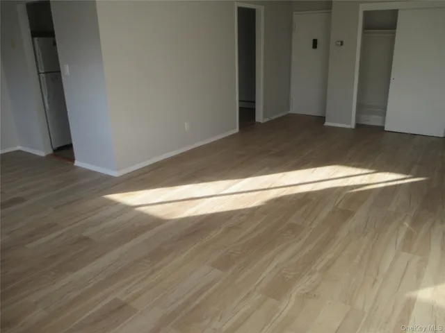 an empty room with wooden floor