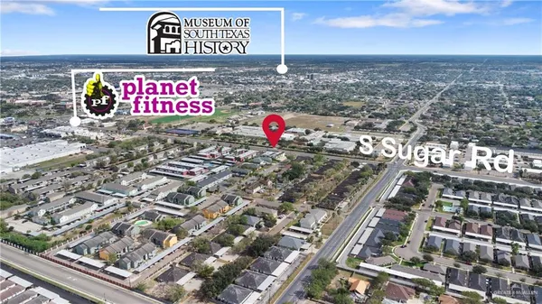 an aerial view of a house with a lake