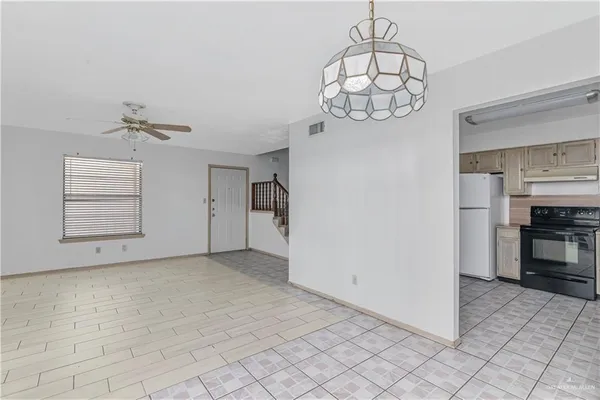 a kitchen with a stove a refrigerator and a sink
