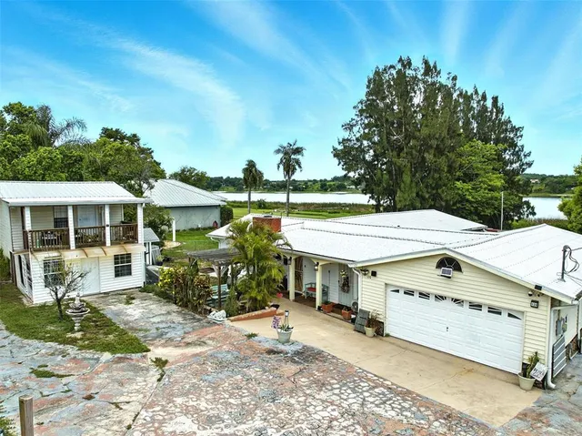 a view of a house with backyard sitting area and garden