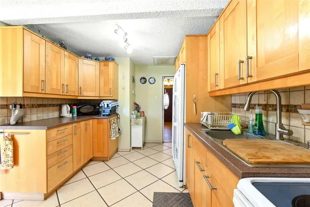a living room with furniture a flat screen tv and large window