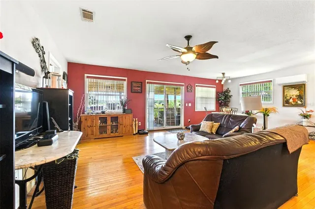 a living room with furniture and wooden floor