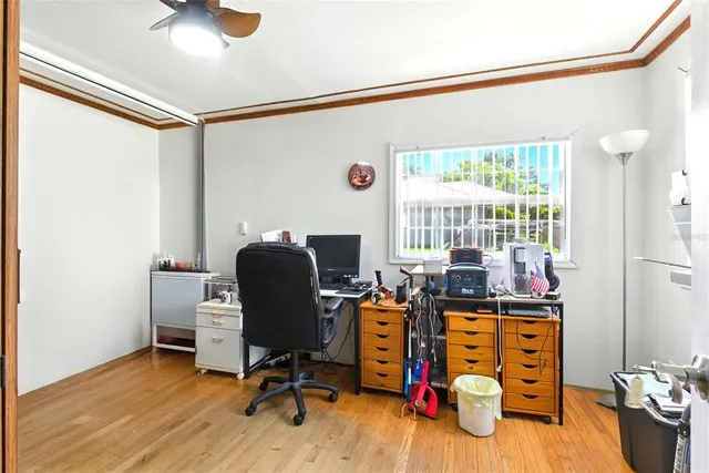 a view of a kitchen with a sink dishwasher a stove top oven a refrigerator with white cabinets and wooden floor