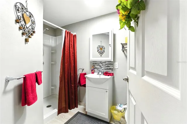 a bathroom with a sink toilet and shower