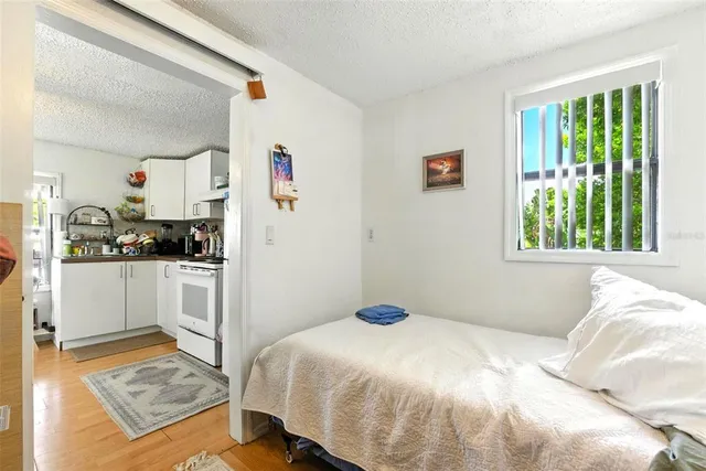 a view of a balcony with chairs and wooden floor