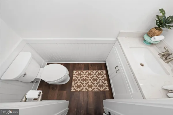 a living room with furniture and a ceiling fan