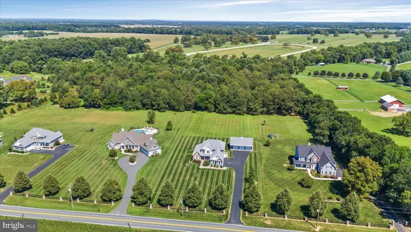 an aerial view of a house with outdoor space pool seating area and yard