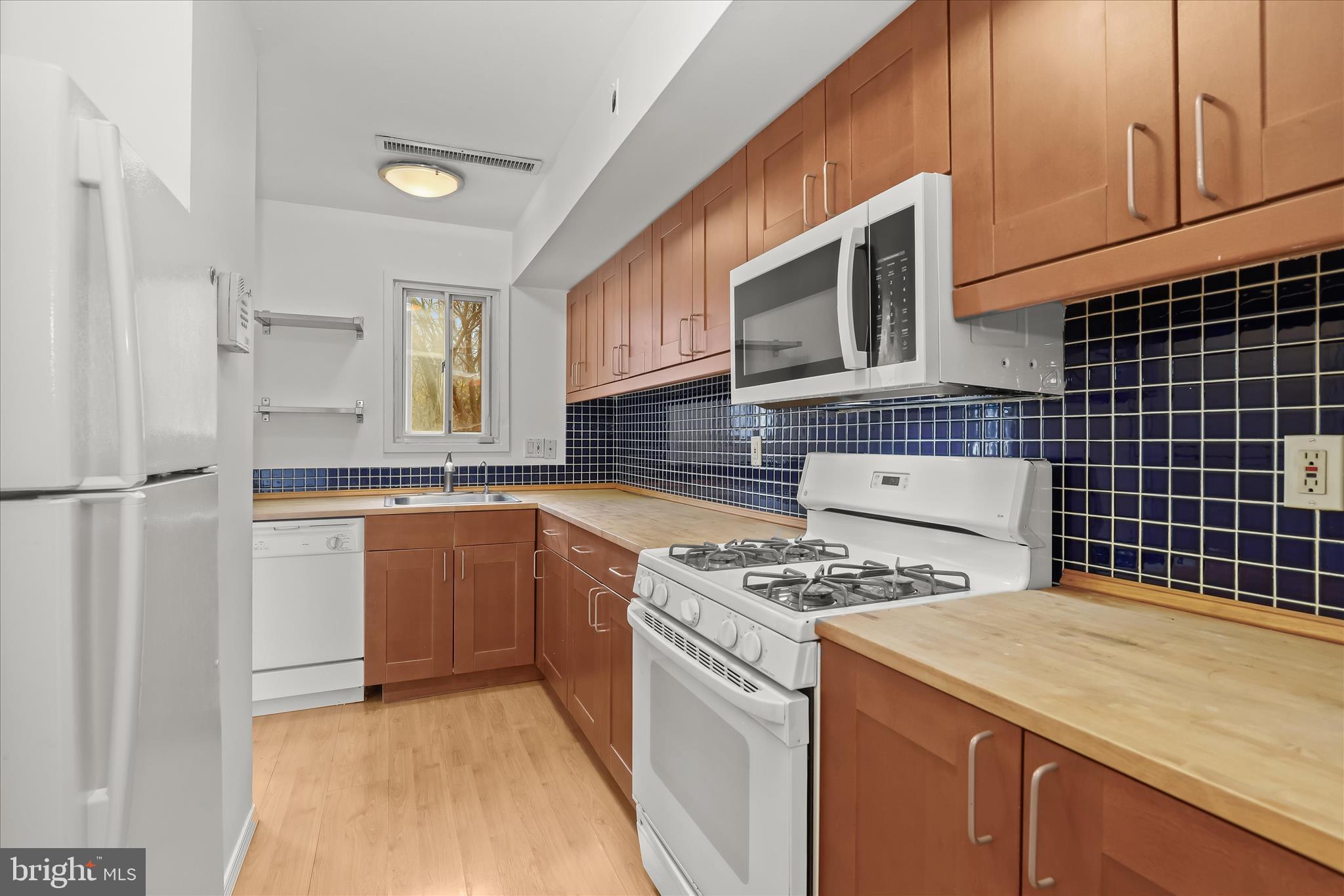 1937 Greenberry Road Baltimore, MD 21209 - Photo 2 of 29 a kitchen with a stove a sink and a refrigerator