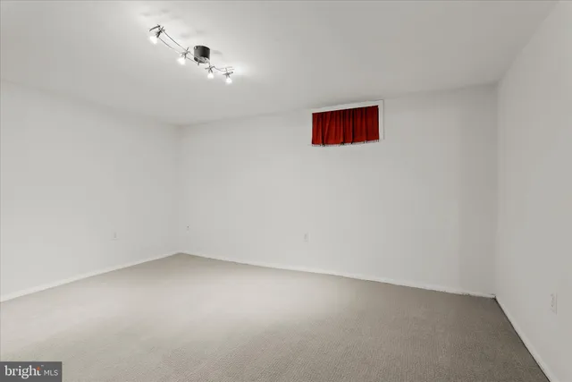 a view of a house with a large window and wooden fence