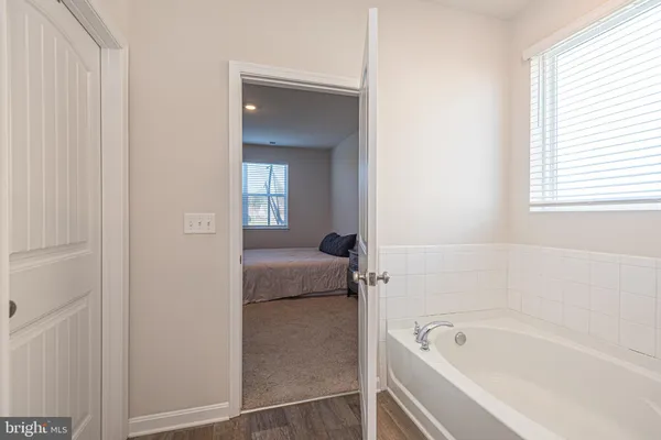 a bathroom with a tub shower and a sink