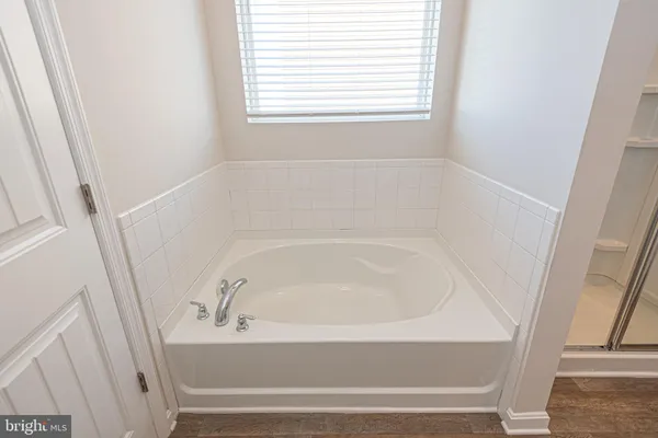 a white bath tub sitting next to a window