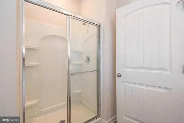 a bathroom with a glass shower door