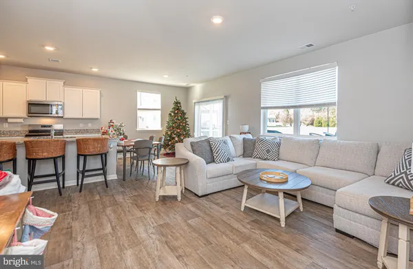 a living room with furniture a wooden floor and a window