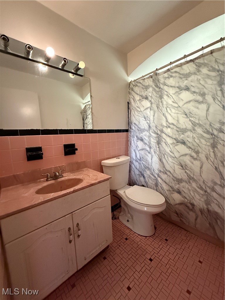 20682 Centuryway Road Maple Heights, OH 44137 - Photo 13 of 16 Bathroom with tile walls, vanity, wainscoting, and a shower with shower curtain