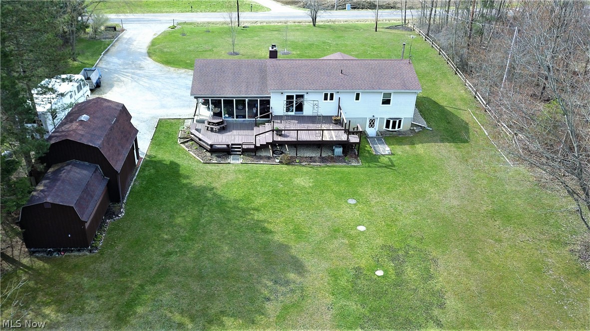 6863 Kennard Road Medina, OH 44256 - Photo 4 of 33 Photo from the Back yard. Look at the size of that Deck and the Shed too. Looks like a Double. See the Walk-out Lower Level? There's plenty of space to park at this house.