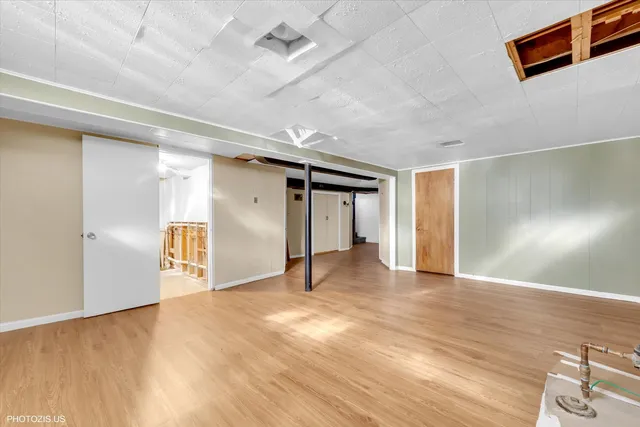 a view of an empty room with closet and a window