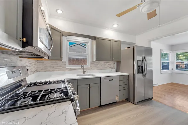 a kitchen with a stove a sink and a refrigerator