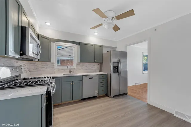 a kitchen with a sink stove and refrigerator