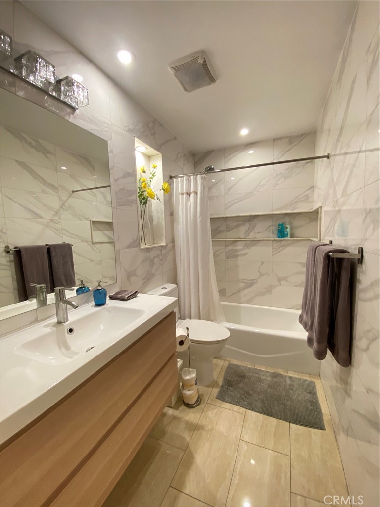 7672 Amazon Drive, Unit 1 Huntington Beach, CA 92647 - Photo 15 of 24 a bathroom with a sink a toilet and shower