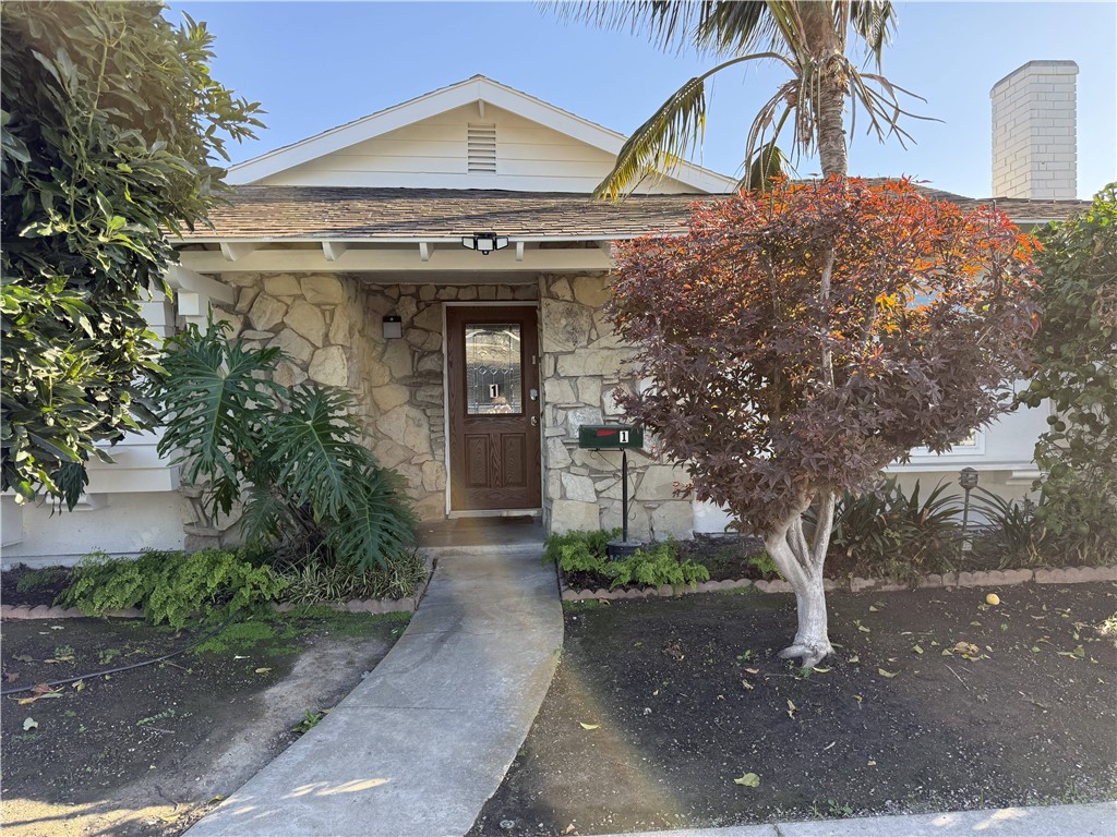 7672 Amazon Drive, Unit 1 Huntington Beach, CA 92647 - Photo 2 of 24 a front view of a house with garden