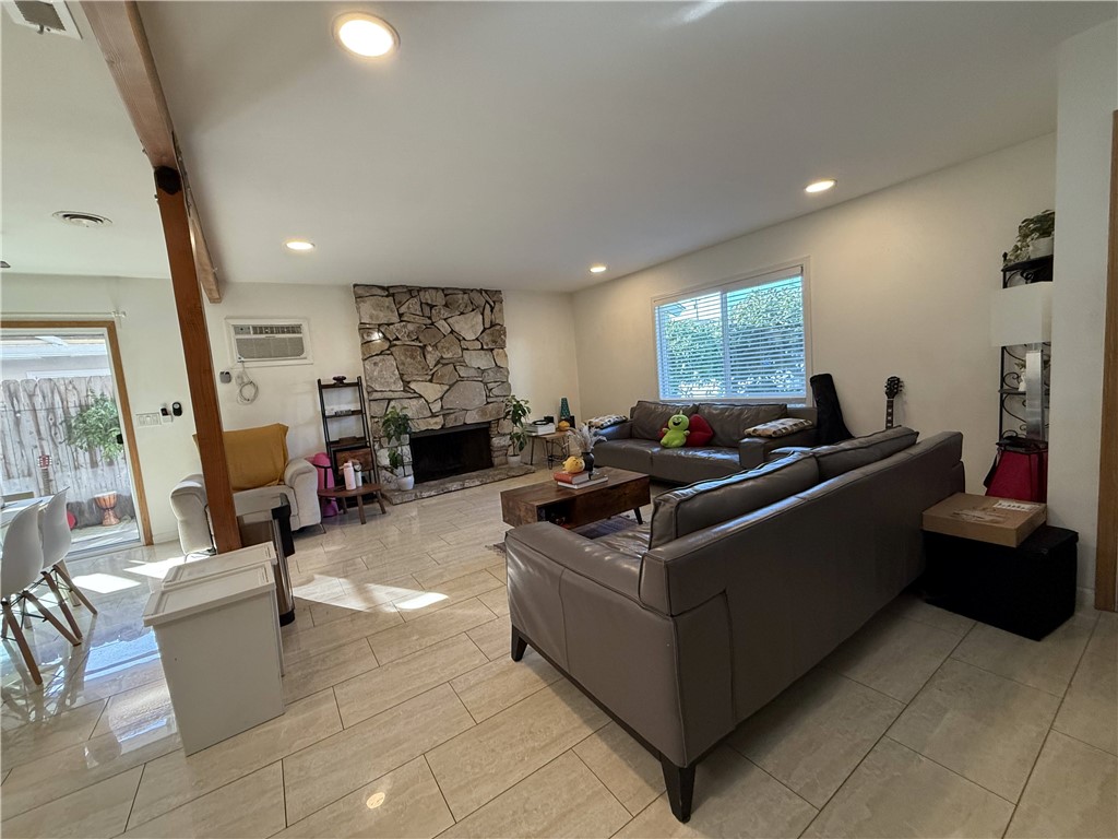 7672 Amazon Drive, Unit 1 Huntington Beach, CA 92647 - Photo 3 of 24 a living room with furniture and a flat screen tv