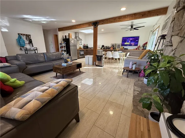 a kitchen with stainless steel appliances wooden floor and a refrigerator