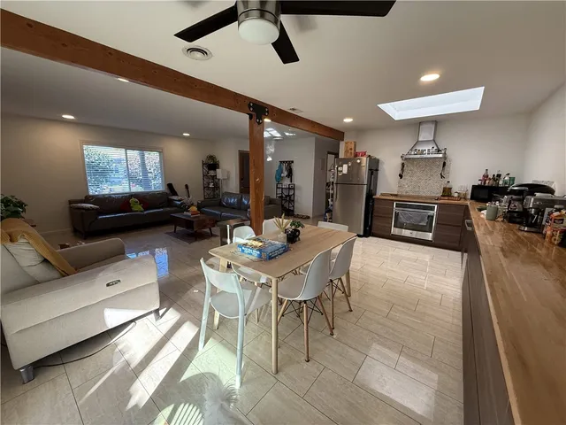 a living room with furniture and kitchen view