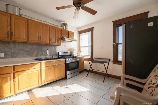 a kitchen with a sink cabinets and window