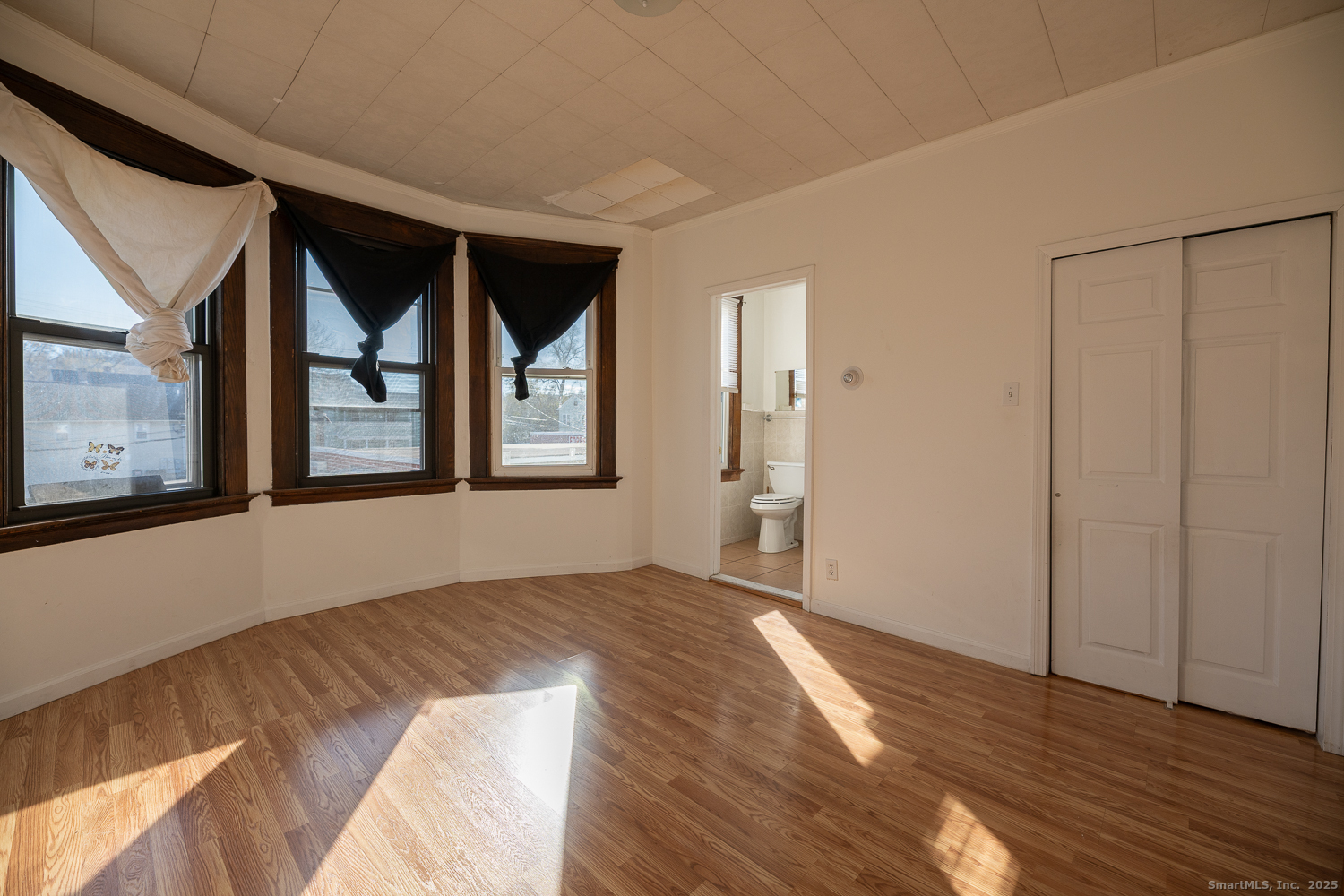 239 Forbes Avenue New Haven, CT 06512 - Photo 8 of 13 a view of an empty room with wooden floor and a window