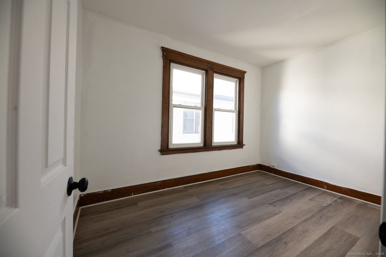239 Forbes Avenue New Haven, CT 06512 - Photo 10 of 13 a view of an empty room with wooden floor and a window