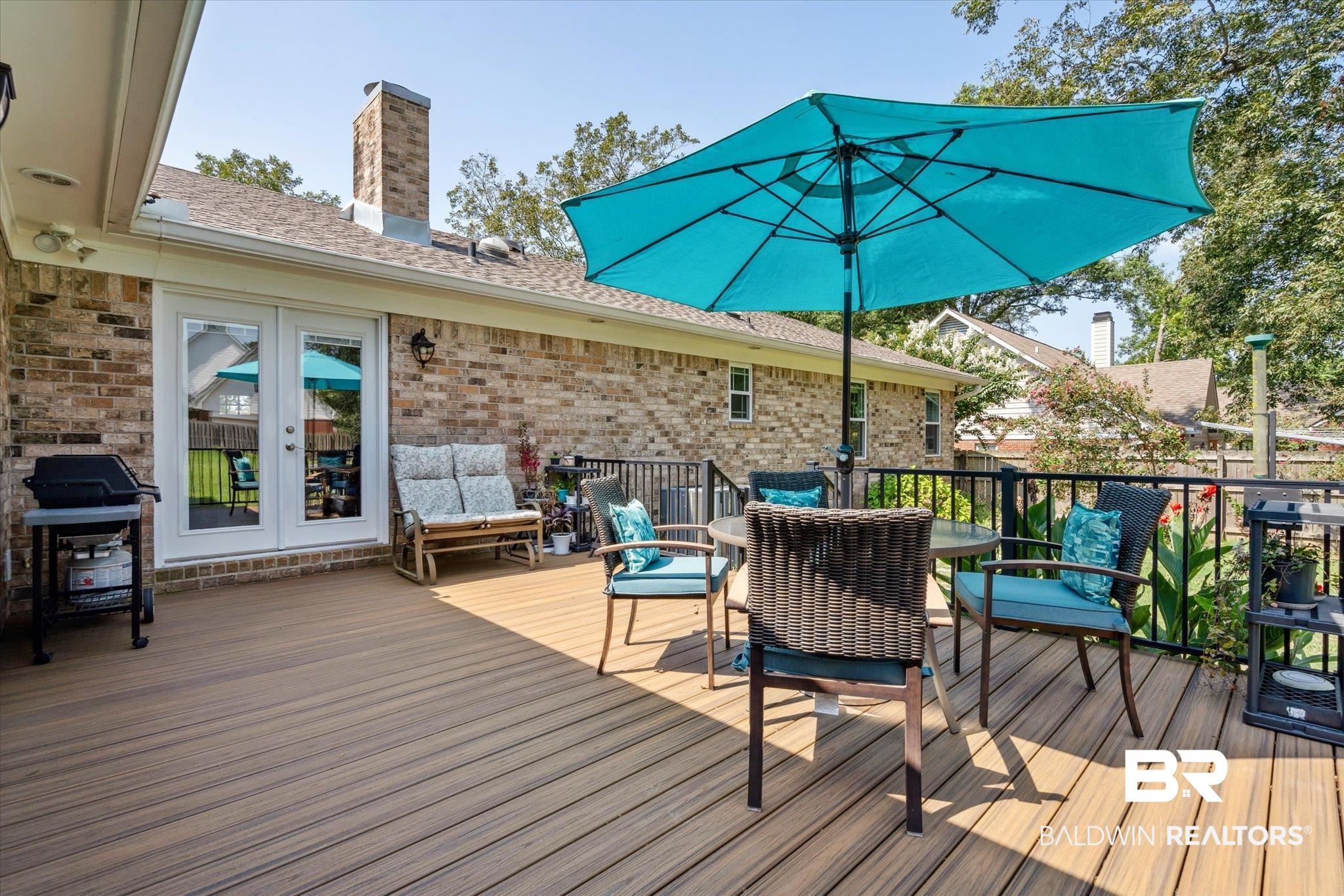 8710 Three Notch Road Mobile, AL 36619 - Photo 22 of 30 Wooden terrace featuring french doors and grilling area