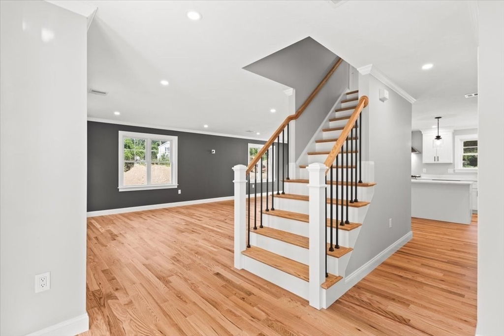 15 Elm Place Hanson, MA 02341 - Photo 11 of 27 a view of a hallway with wooden floor and stairs