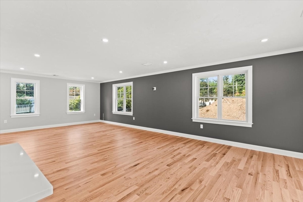 15 Elm Place Hanson, MA 02341 - Photo 13 of 27 a view of an empty room with wooden floor and a window