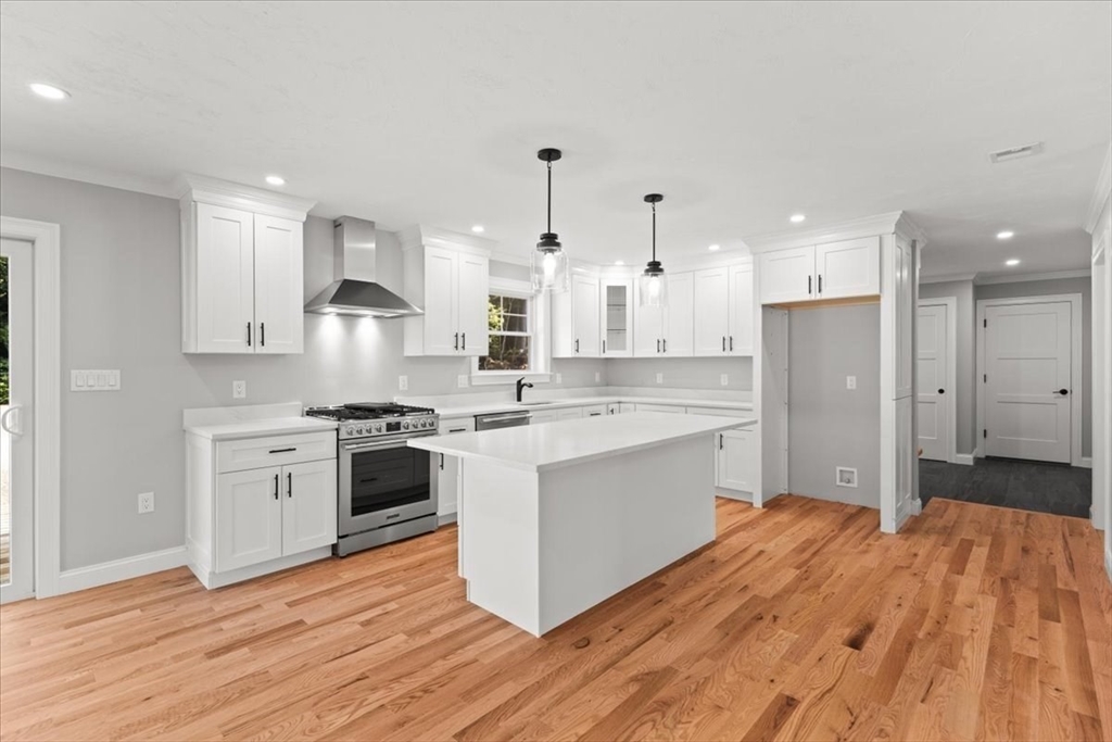 15 Elm Place Hanson, MA 02341 - Photo 16 of 27 a large kitchen with stainless steel appliances granite countertop a stove a sink dishwasher and a refrigerator with wooden floor