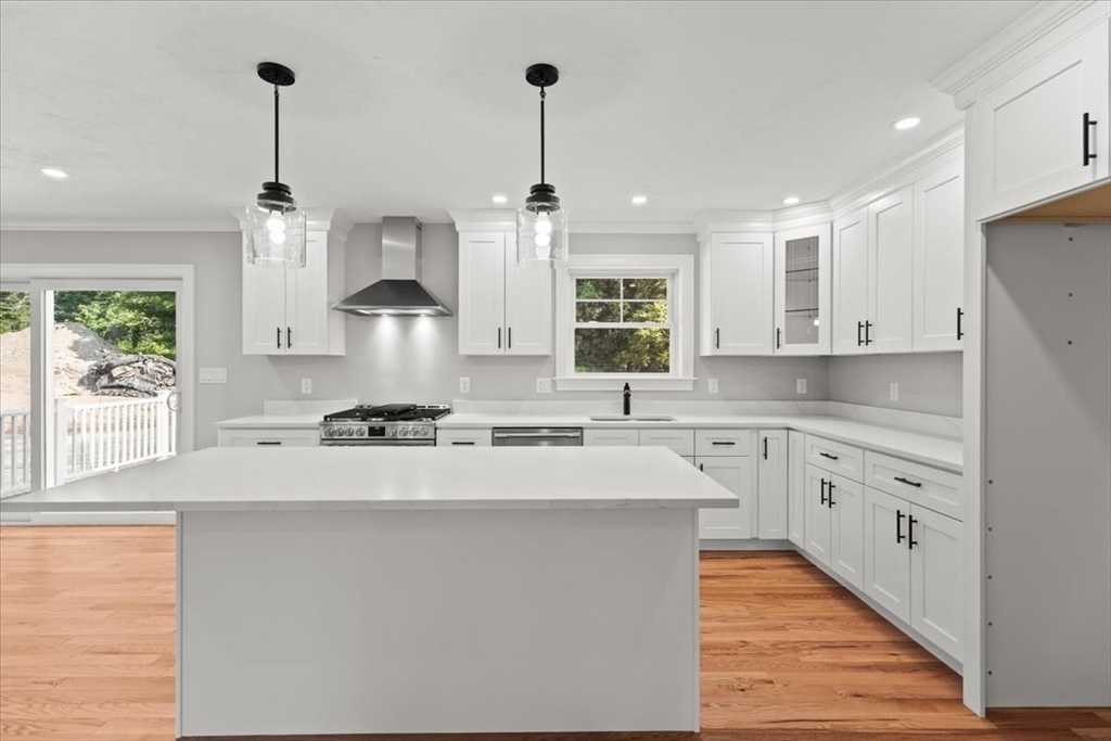 15 Elm Place Hanson, MA 02341 - Photo 20 of 27 a kitchen with stainless steel appliances granite countertop a sink stove and refrigerator