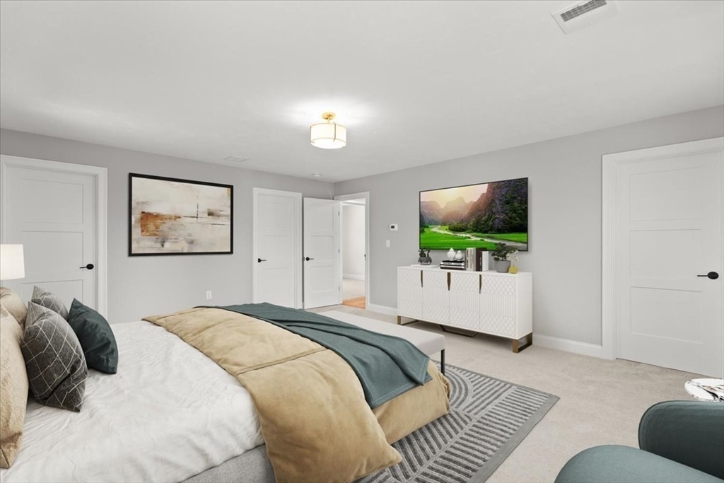 15 Elm Place Hanson, MA 02341 - Photo 21 of 27 a bedroom with a large bed and a flat screen tv