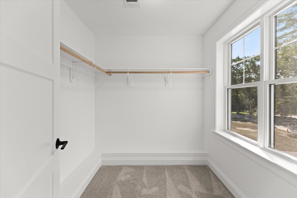 15 Elm Place Hanson, MA 02341 - Photo 24 of 27 a view of a room with rack on the wall and a window