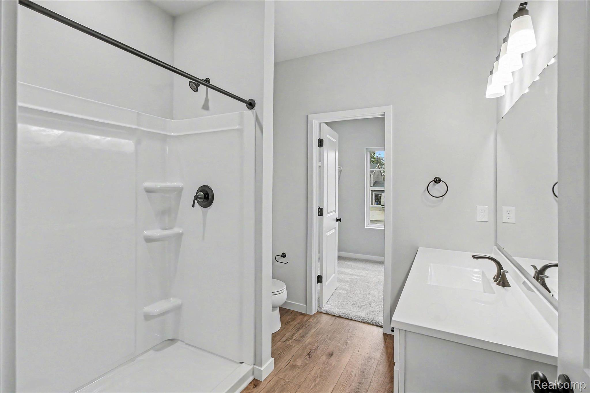 1210 Lockes Street Howell, MI 48843 - Photo 11 of 37 The primary suite is located on the upper level and includes a private bath and oversized walk-in closet with large window for natural lighting.