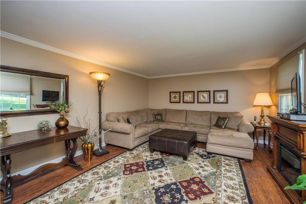 2344 Harrow Road Pittsburgh, PA 15241 - Photo 3 of 25 The living room boasts plenty of good wall space for arranging furniture. Featuring painted walls topped with crown molding and recently added easy care laminate floors.