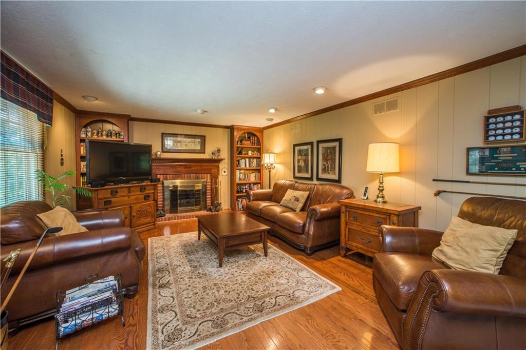 2344 Harrow Road Pittsburgh, PA 15241 - Photo 7 of 25 The recessed lighting showcases the fireplace and built ins in this family room.