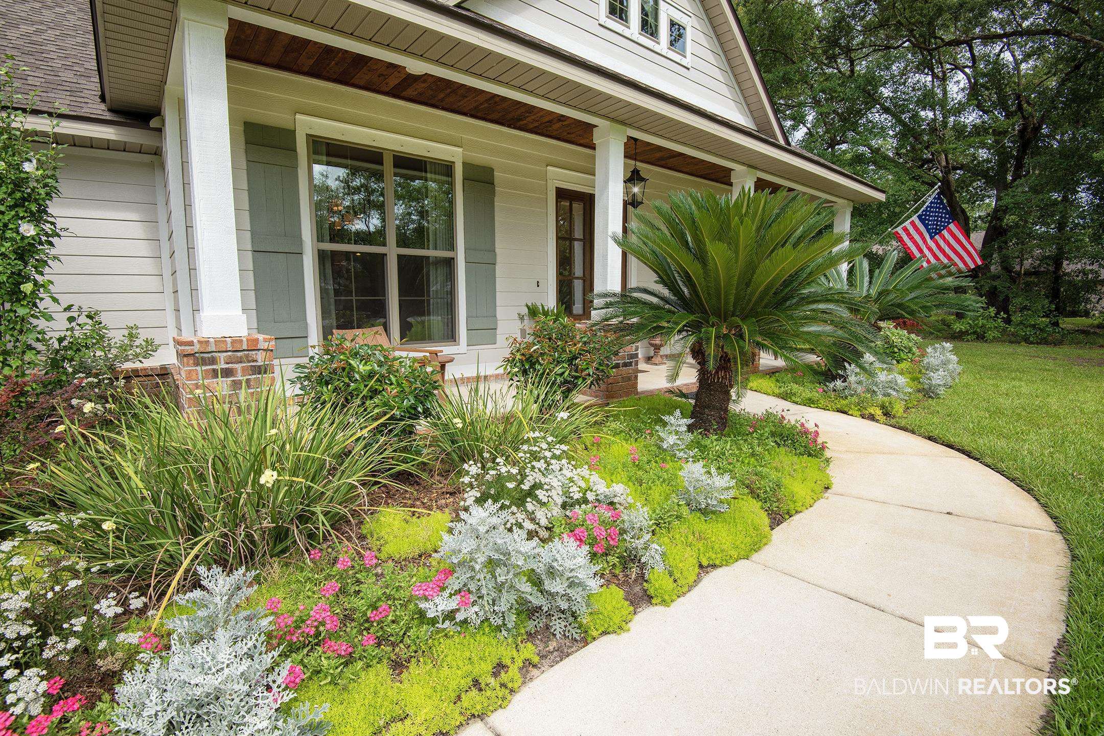 18754 Treasure Oaks Road Gulf Shores, AL 36542 - Photo 5 of 53 Curved concrete pathway leading to a welcoming front porch