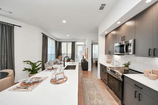 a bathroom with a double vanity sink mirror and shower